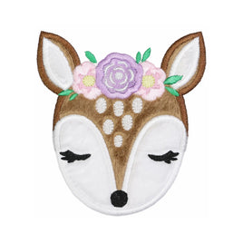 Floral deer face embroidered patch with plush tan fur detail, white muzzle and ears, closed eyes with lashes, and pastel flower crown in lavender and pink, iron on or sew on applique for baby clothes or backpacks