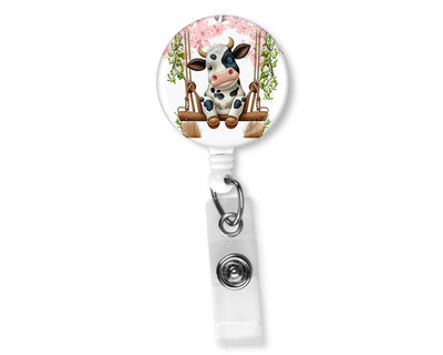 Black and White Swinging Cow Badge Reel