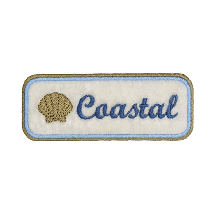 coastal seashell embroidered patch with script text and beach inspired design
