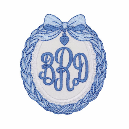 Blue coquette bow monogram embroidered patch with heart charm detail, personalized oval patch for bags jackets baby blankets and nursery projects