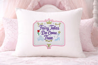 Decorative pillow with 'Fairy Tales Do Come True' embroidery on a pink background