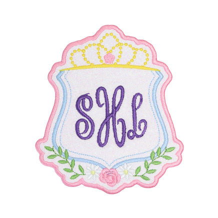 Princess crown crest monogram embroidered patch with scalloped pink border, pastel shield frame, floral accents, and custom script initials, perfect for personalized backpacks, jackets, dresses, and boutique accessories