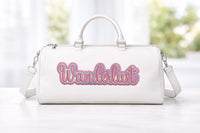 White handbag with 'Wanderlust' text in pink on a mother of pearl background