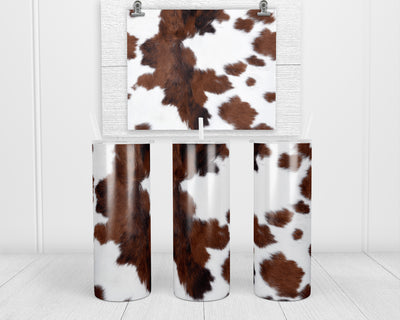 Brown and White Cowhide 20 oz insulated tumbler with lid and straw